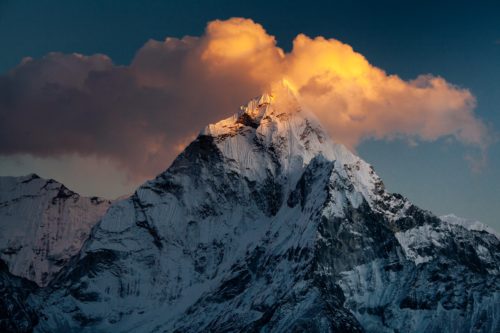 A snowy mountain peak at sunset